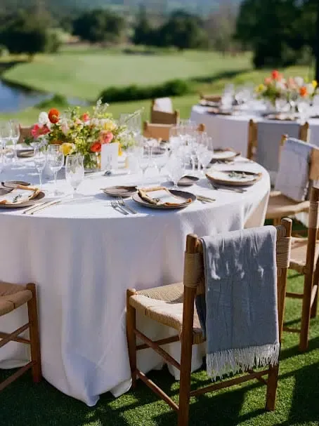round table with white linen and elegant tableware on top