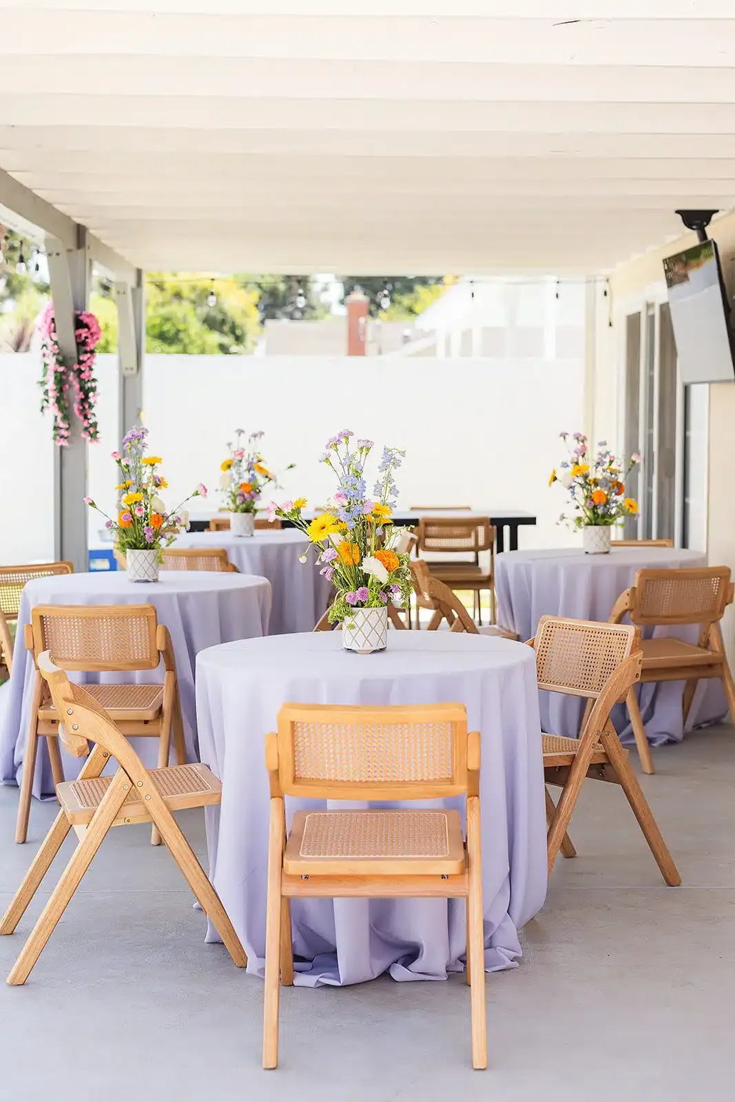 purple table linen and wooden chairs