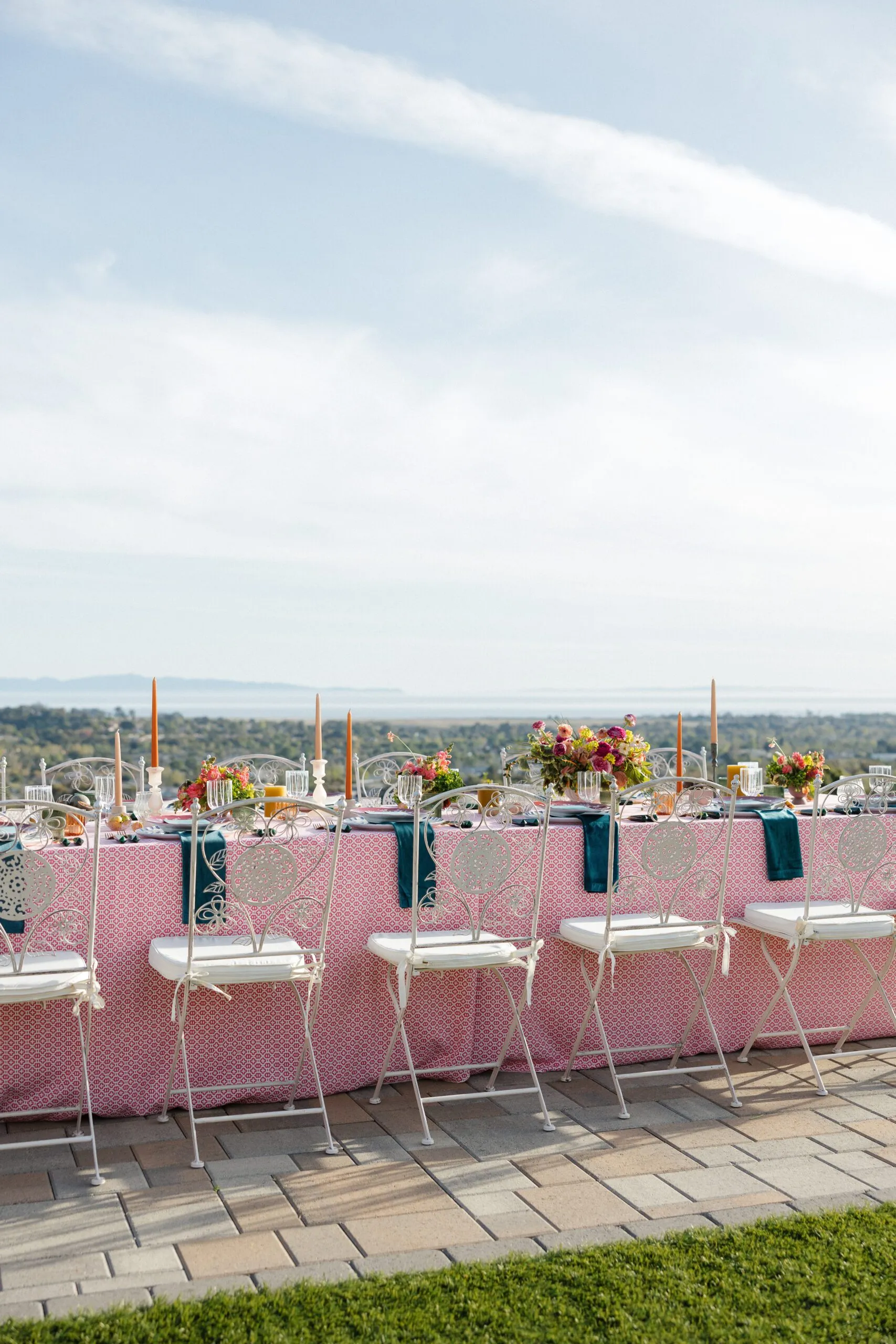 pink table linen and white chairs