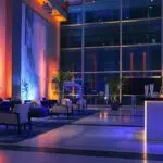 a sleek, modern corporate event space adorned with elegant lighting and dynamic seating arrangements, designed to foster networking and collaboration among upscale attendees.