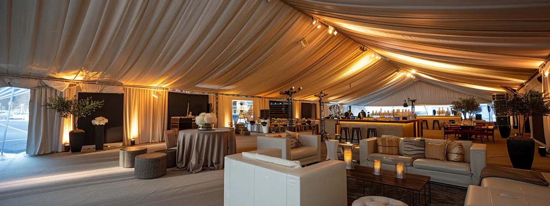 a sophisticated interior of a tent rental showcases distinct functional zones with elegant furnishings, ambient lighting, and sleek decor, perfect for hosting impactful conferences and trade shows.