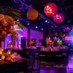 a lavishly decorated indoor event space filled with elegant table settings, vibrant balloons, and tasteful lighting, exuding a festive atmosphere perfect for personalizing private parties and celebrations.