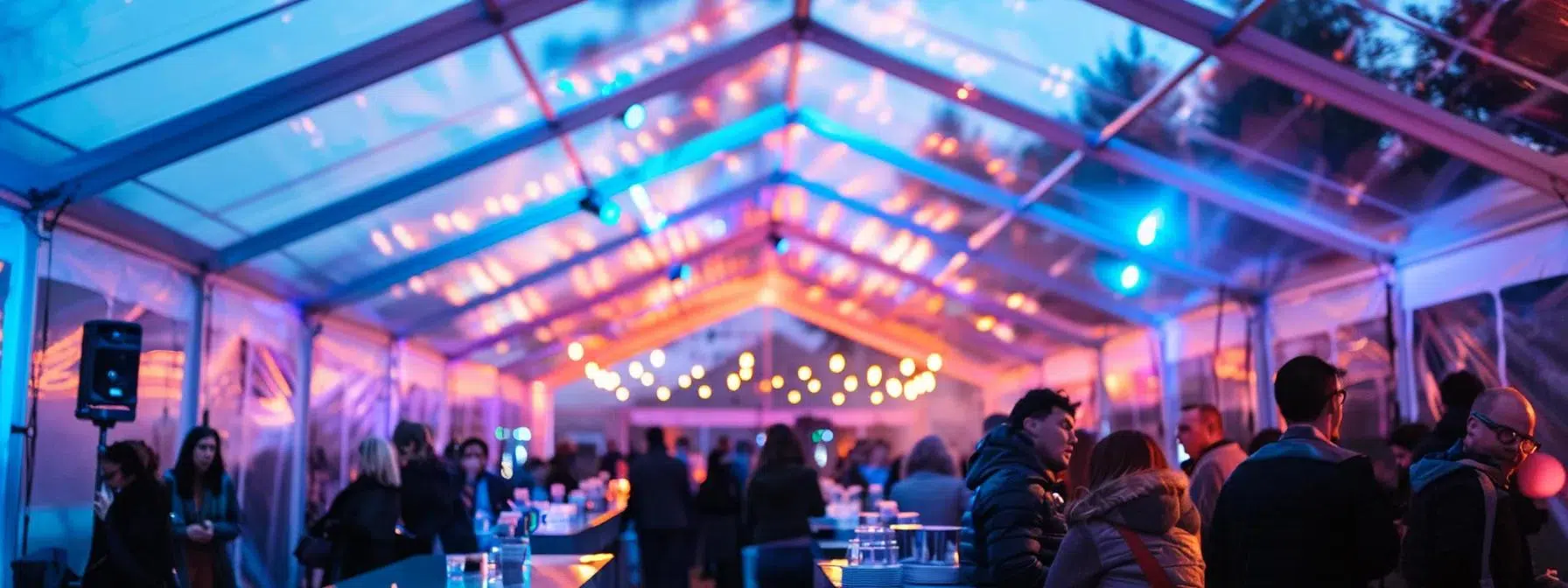 a brightly lit, modern tented venue filled with guests comfortably enjoying a social event, featuring visible ventilation equipment and air flow indicators to emphasize the importance of air quality and circulation.