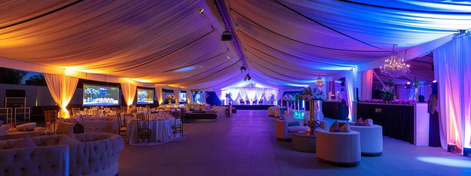 a well-organized event space showcases an elegant tent with sophisticated lighting and decor, highlighting the professionalism of a reliable tent rental service.