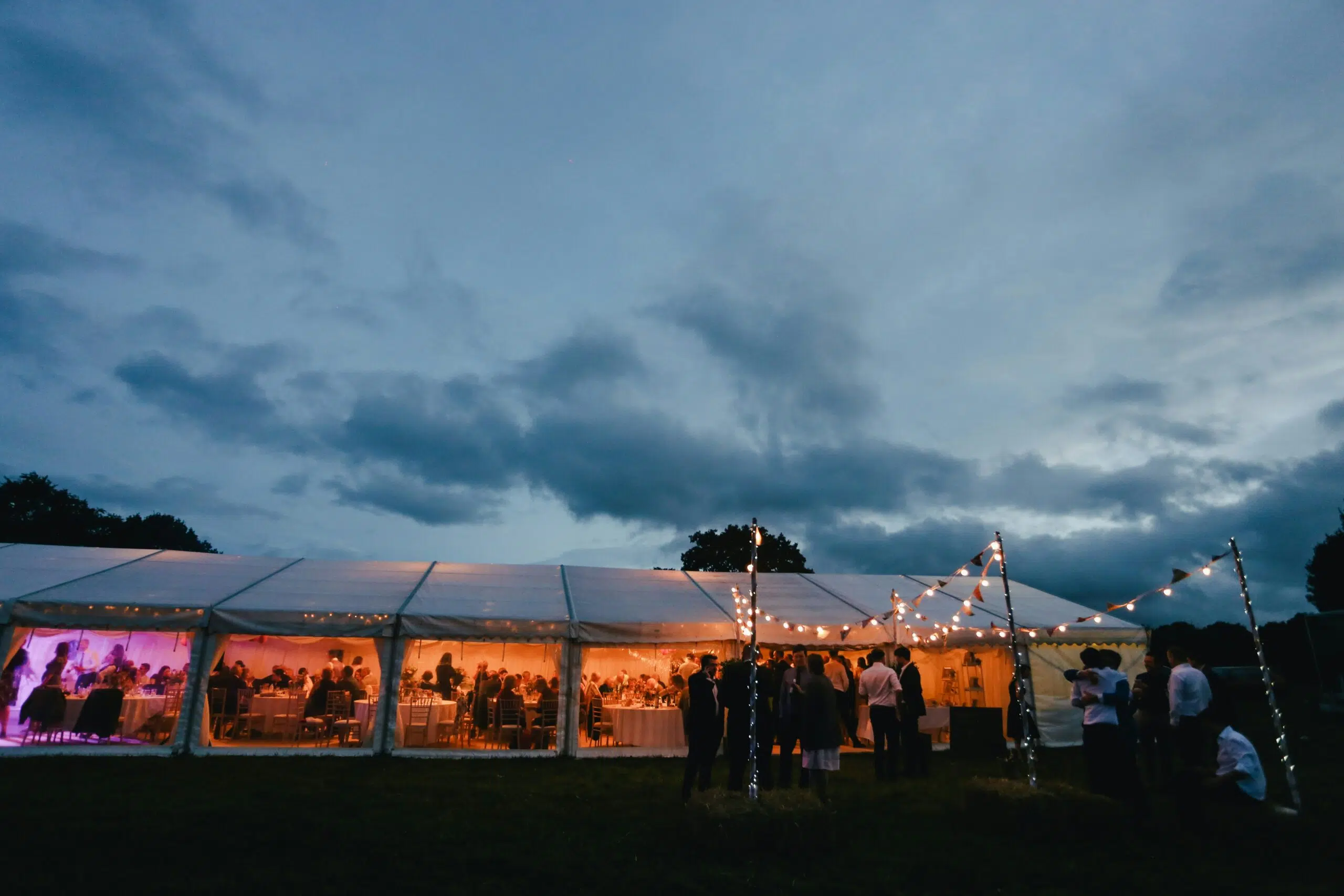 ongoing event under a tent with guest mingling