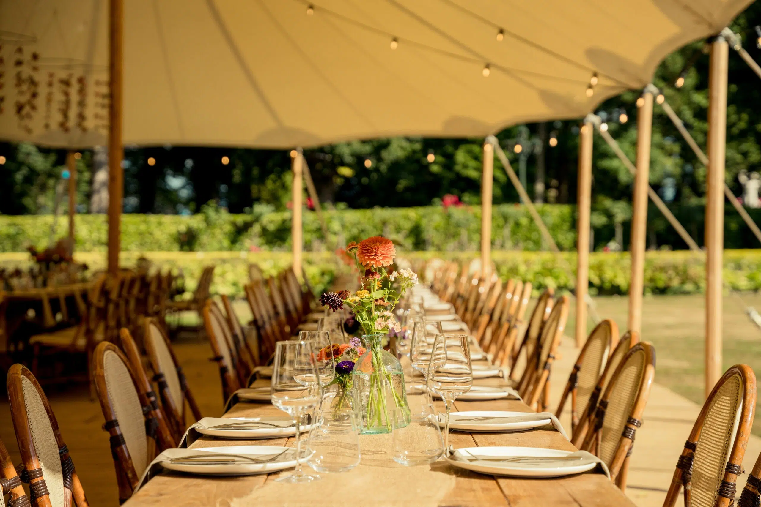 outdoor event table setup under a tent