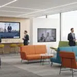 Corporate networking lounge with comfortable seating and professionals engaging in conversation