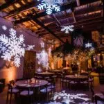 Cozy winter event lighting with uplights and snowflake projections creating a magical atmosphere