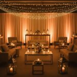 Warmly lit event space with amber uplighting and string lights creating an inviting atmosphere