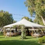 Colorful outdoor tent setup for seasonal events in Southern California, highlighting floral decorations and ambient lighting