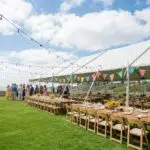 Outdoor wedding tent rental setup in Ventura County with tables and decorations