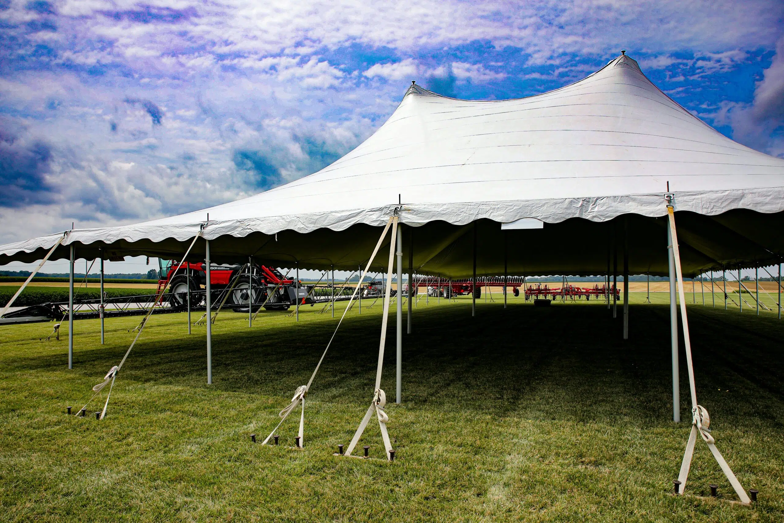 big white tent setup at a huge lawn