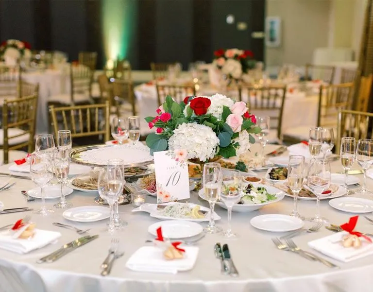 Elegant dining table setup for a family-friendly event, featuring floral centerpiece, plates of food, and decorative place settings, reflecting Ventura Rental Party & Events' commitment to creating inviting kids' zones and safe gathering spaces.