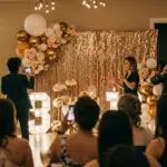 Colorful milestone birthday backdrop with sequin and floral elements, showcasing a festive celebration