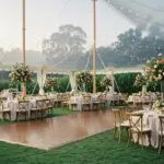 Elegant outdoor wedding tent in Santa Barbara featuring polished wood and plush carpet flooring