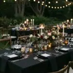 Luxury wedding tablescape with elegant linens and fine china in a sophisticated outdoor setting