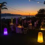 Outdoor party in Santa Barbara with specialty lighting creating a warm and inviting atmosphere