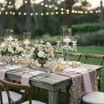 Rustic and glam wedding table setting with sequin linens and natural wood elements