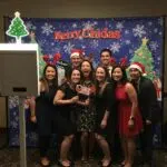 Festive holiday photo booth with cheerful guests and seasonal props
