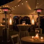 Outdoor winter event in Ventura with patio heaters providing warmth to guests