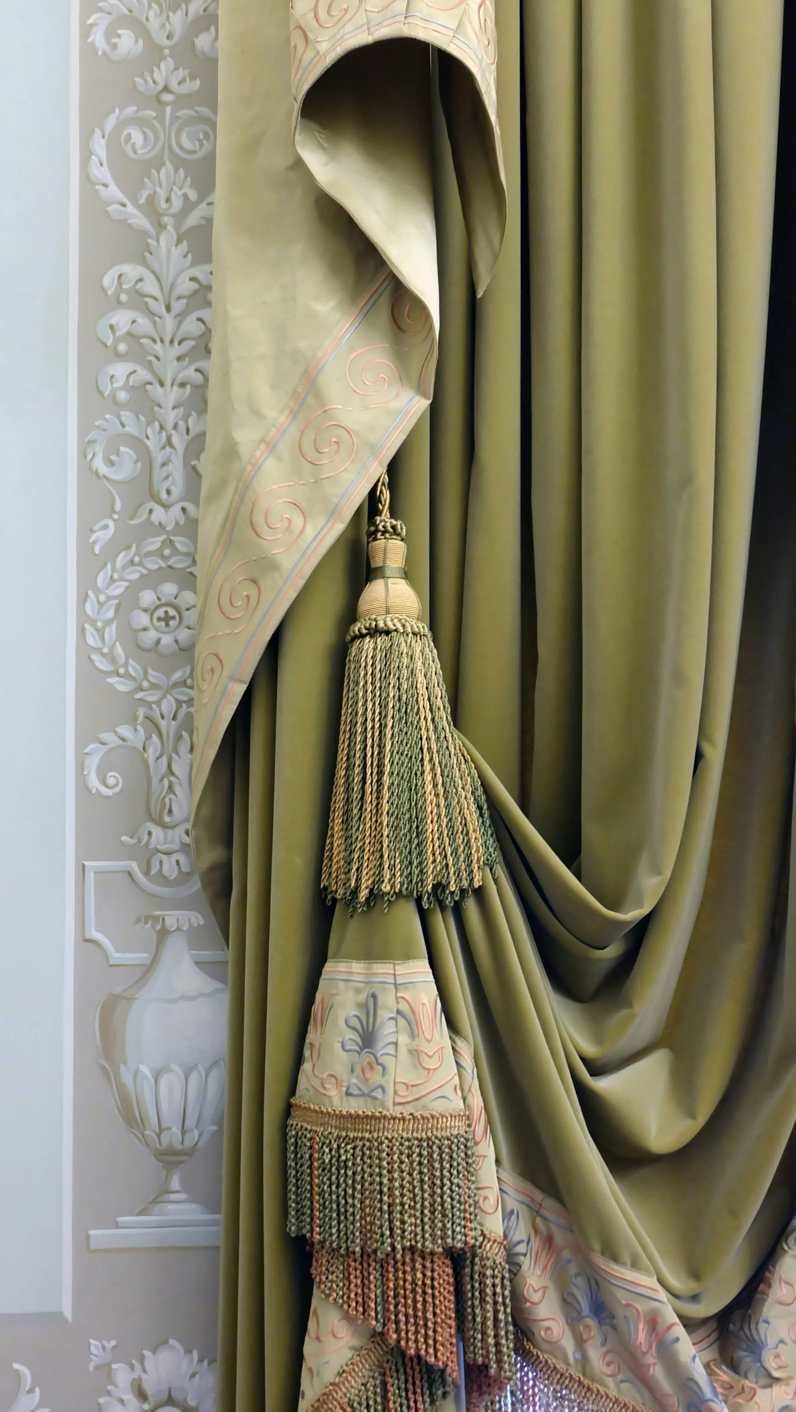 Elegant drapery showcasing textured fabric with decorative tassels and embroidered detailing, enhancing venue aesthetics for events.