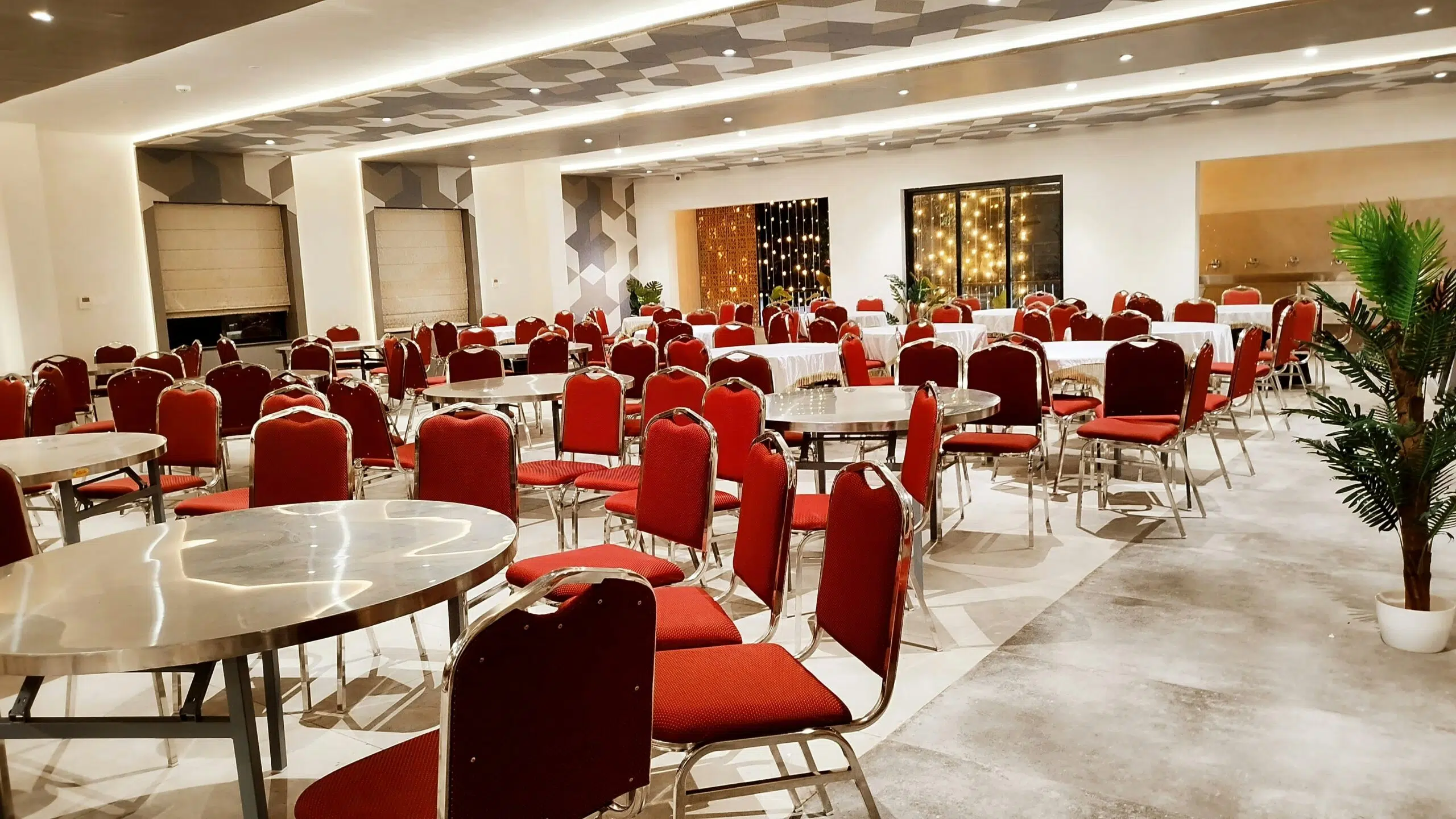 Event space with red chairs and tables arranged for winter gatherings, highlighting climate control solutions for Los Angeles events.