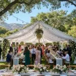 Outdoor wedding tent setup in Ventura County with guests and decorations