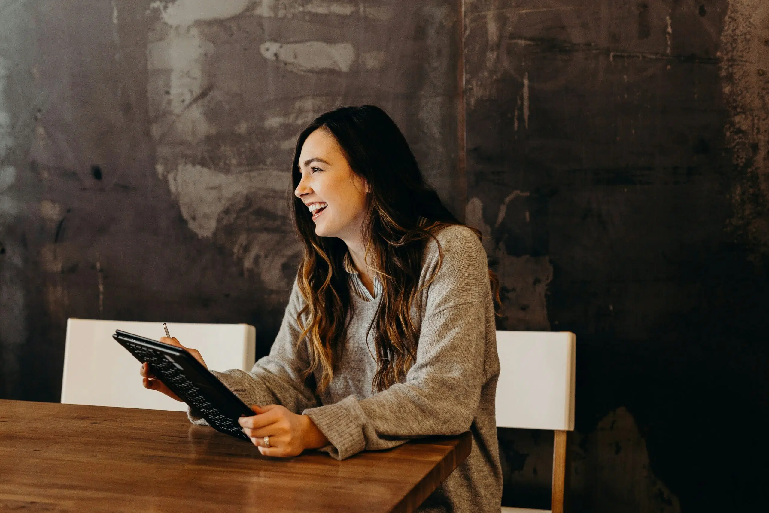 a woman smiling in a conference room
