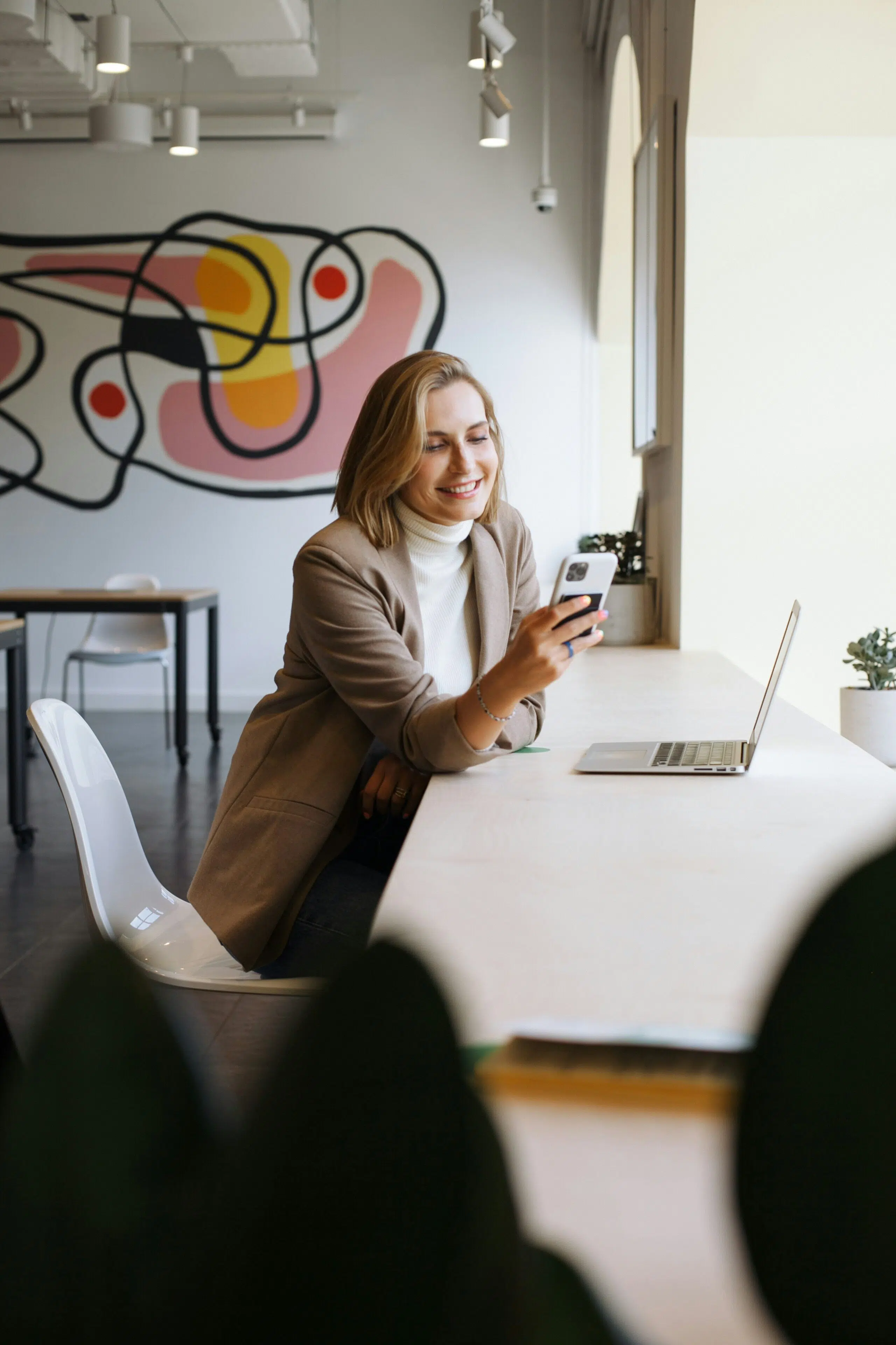 a woman smiling while using her phone