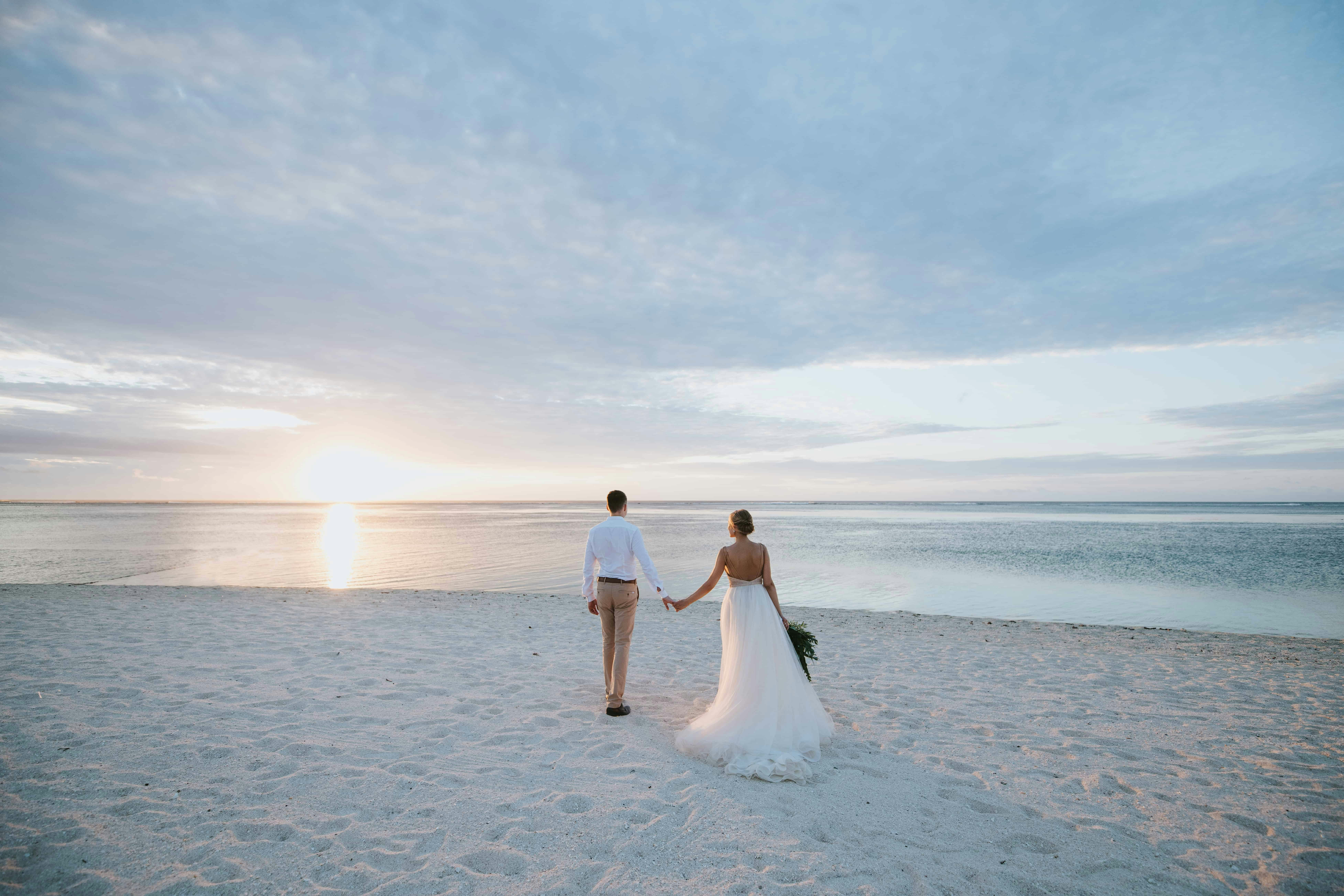 a couple on the beach at a wedding