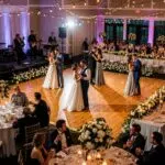Wedding dance floor with couples dancing, showcasing vibrant atmosphere and elegant decorations