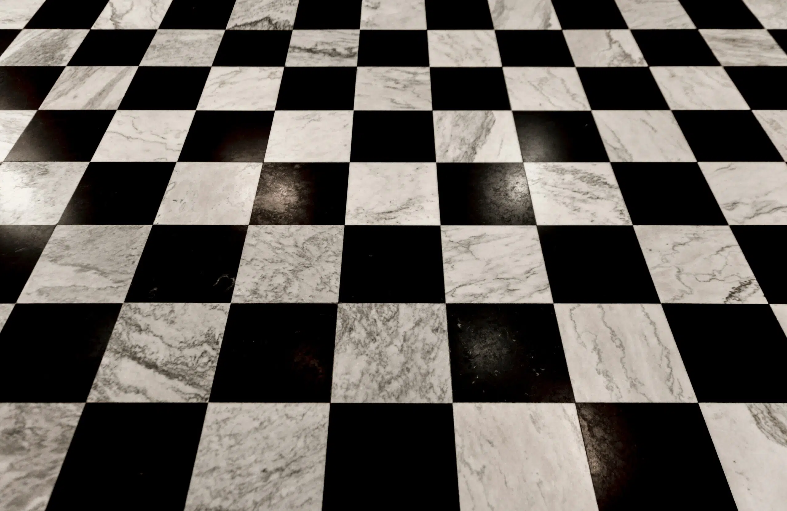 Checkerboard dance floor featuring alternating black and white tiles, suitable for wedding receptions and events, enhancing ambiance and guest experience.
