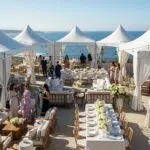 Outdoor gala setup in Coastal California with tents and elegant furniture
