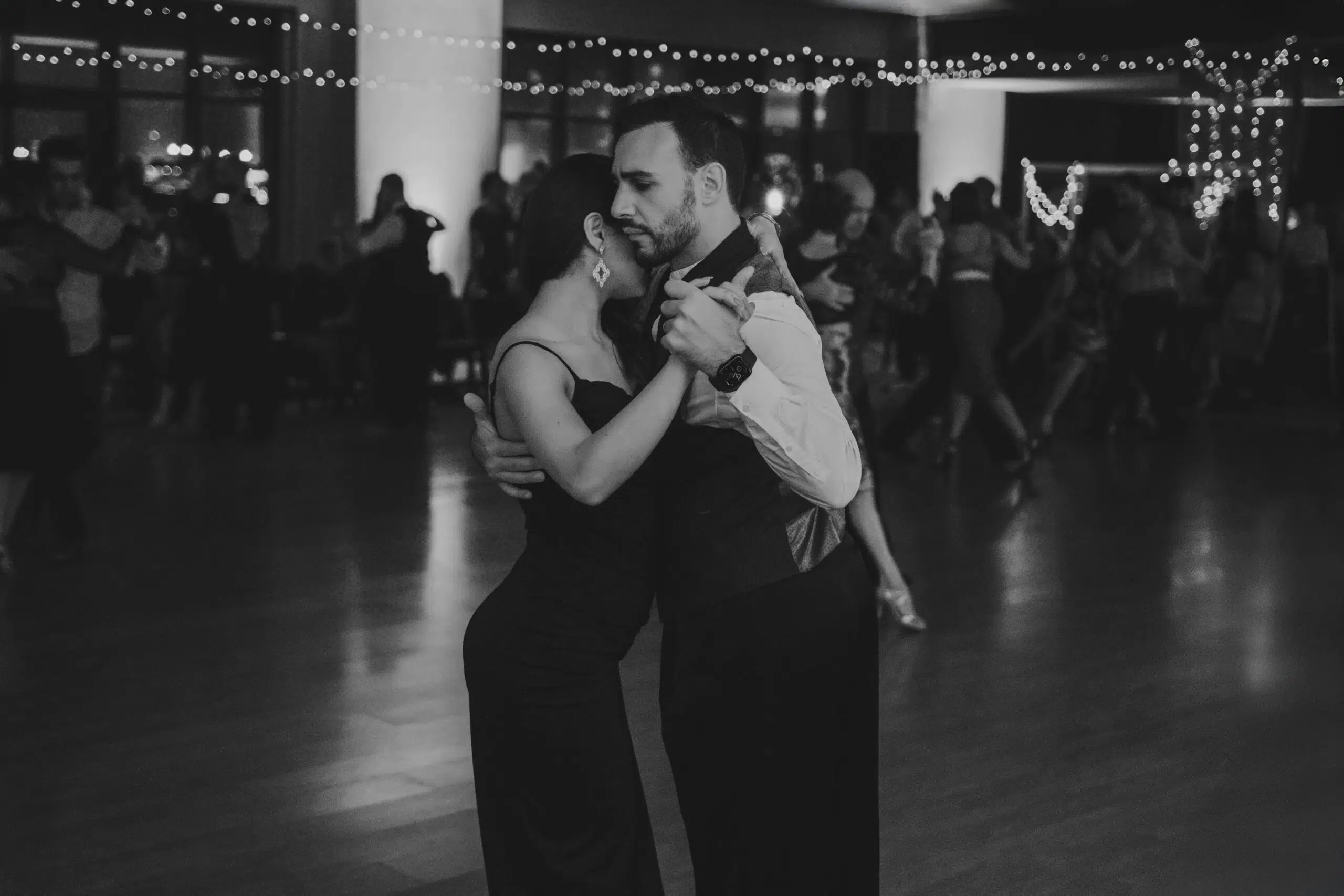 black and white image of a couple dancing at a wedding