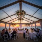 Clear-top wedding tent on the beach with sunset view and elegant decor