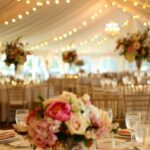 event with tent, lighting, chairs and tables, flowers, linens for summer