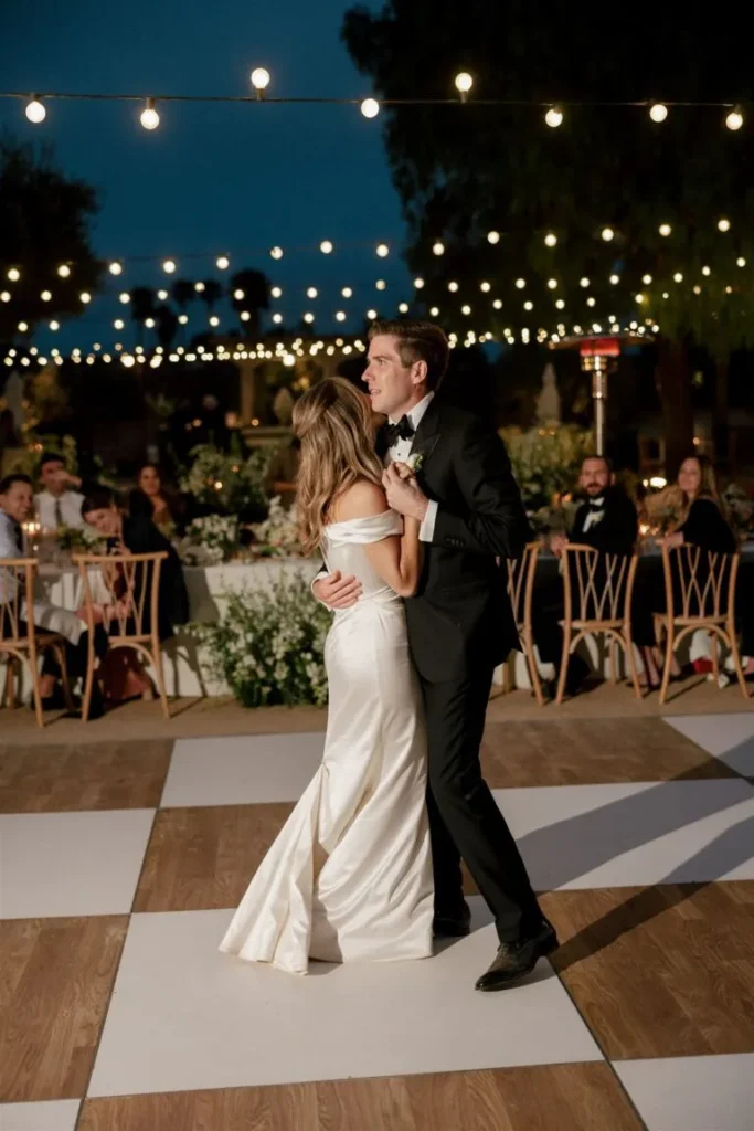 couple dancing under lights on a dancefloor