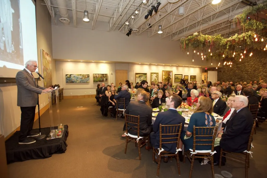 Speaker at a podium facing seated guests at a Santa Barbara event