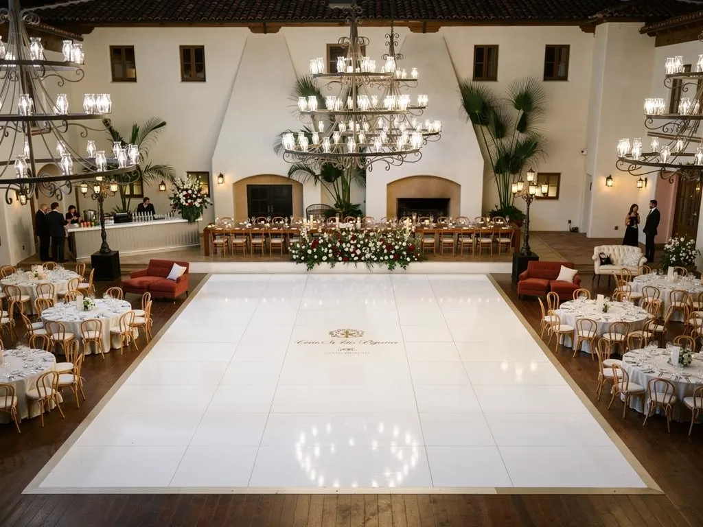 Large custom dance floor integrated with dining tables at an indoor event