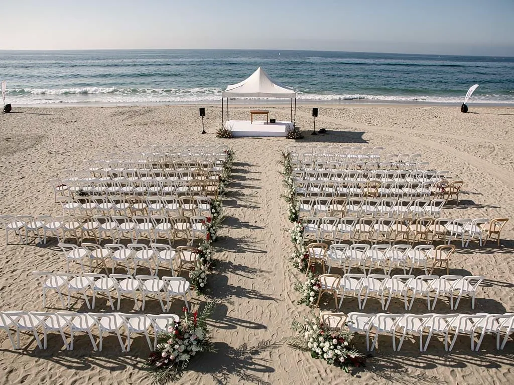 Santa Barbara beach ceremony setup with rows of chairs and a small canopy
