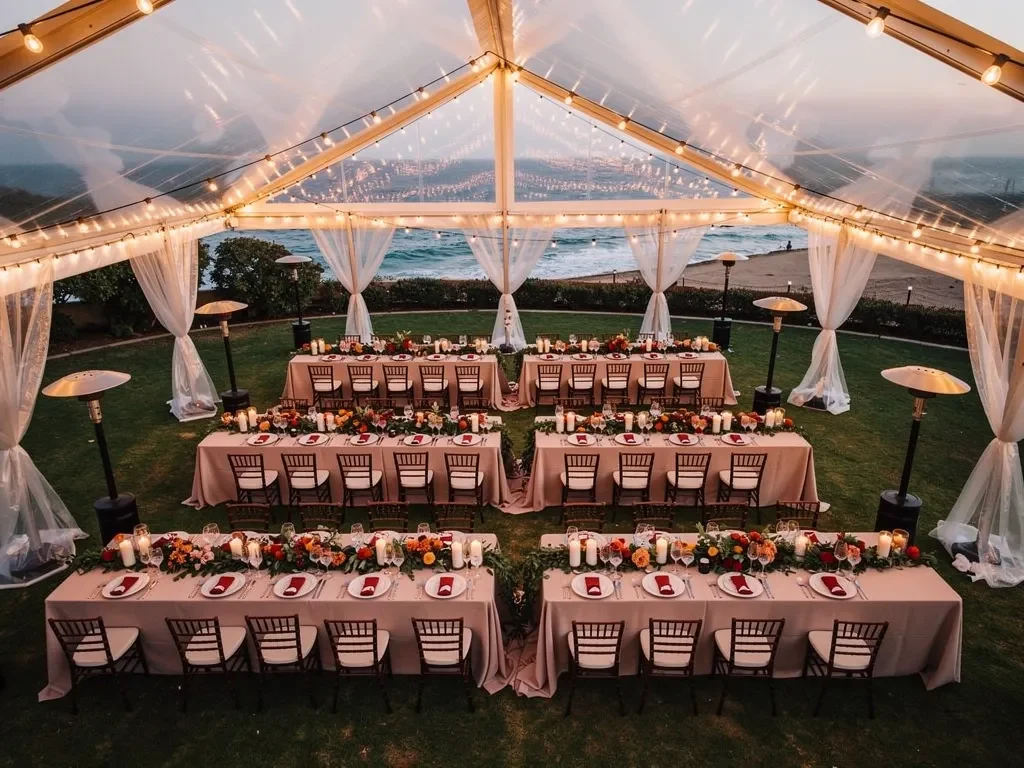 Stunning clear-span wedding tent at a luxury fall outdoor celebration with fairy lights and rich